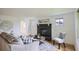 Comfortable living room boasts a black fireplace, natural light, and stylish decor at 5563 Newland Way, Arvada, CO 80002