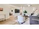 Open living room with hardwood floors, contemporary decor, and access to other rooms at 5563 Newland Way, Arvada, CO 80002