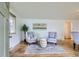 Open floor plan with hardwood floors, comfortable seating, and smooth access to dining area at 5563 Newland Way, Arvada, CO 80002