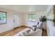 Bright living room with natural light, hardwood floors and neutral decor at 5563 Newland Way, Arvada, CO 80002