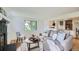 Open-concept living area with fireplace and view into the updated kitchen at 5563 Newland Way, Arvada, CO 80002