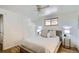 Well-lit main bedroom offers hardwood floors, neutral color palette, and closet at 5563 Newland Way, Arvada, CO 80002