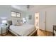 Serene main bedroom features neutral tones, natural light, and ensuite bathroom at 5563 Newland Way, Arvada, CO 80002