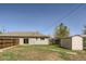 Large backyard features a wood fence, a storage shed, and a home with sliding glass doors at 1121 Rogers St, Golden, CO 80401