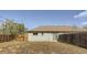 This backyard features a wood fence, a storage shed, a home with siding, and a clear blue sky at 1121 Rogers St, Golden, CO 80401