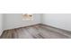 Bright bedroom showcasing wood-look flooring, white trim, and a view of the neighborhood at 4598 Boone Cir, Brighton, CO 80601