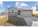 Charming home featuring stone accents, a well-kept lawn, and an attached two-car garage at 4598 Boone Cir, Brighton, CO 80601