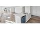 Kitchen island with a sleek design, modern appliances, and a view of the expansive living space at 4598 Boone Cir, Brighton, CO 80601