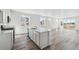 Spacious kitchen island featuring a modern sink, dishwasher, and white cabinetry at 4598 Boone Cir, Brighton, CO 80601