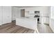 Open-concept kitchen featuring a center island with a sink and seating area, ample counter space and cabinets at 4598 Boone Cir, Brighton, CO 80601