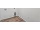 A bright laundry room with wood-look flooring and modern utility connections at 4598 Boone Cir, Brighton, CO 80601