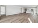 A large living room with wood-look flooring leading to the kitchen, showcasing a modern, open layout at 4598 Boone Cir, Brighton, CO 80601