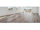 Spacious living room with wood-look flooring, flooded with natural light from large windows and sliding doors at 4598 Boone Cir, Brighton, CO 80601