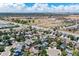 Expansive aerial view of a community, with homes, green spaces, and roads, highlighting the area's scale and layout at 8847 Cloverleaf Cir, Parker, CO 80134