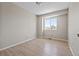 Cozy bedroom featuring neutral walls, wood floors, and a bright window at 8847 Cloverleaf Cir, Parker, CO 80134