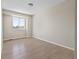 Bedroom featuring neutral walls, wood floors, and a bright window at 8847 Cloverleaf Cir, Parker, CO 80134