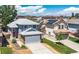 Exterior view of a well-maintained two-story home with a two-car garage and a manicured lawn at 8847 Cloverleaf Cir, Parker, CO 80134