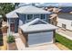 Two-story home with a gray exterior, brick accents, and a two-car garage, offering curb appeal at 8847 Cloverleaf Cir, Parker, CO 80134