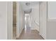 Hallway with neutral walls, wood floors, and a bathroom and bedroom visible at 8847 Cloverleaf Cir, Parker, CO 80134