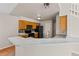 Well-lit kitchen featuring wood cabinets, black appliances, and a breakfast bar for convenient meal prep and casual dining at 8847 Cloverleaf Cir, Parker, CO 80134