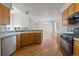 The kitchen has light countertops, wood cabinets, stainless steel dishwasher, and flows to a living/dining area at 8847 Cloverleaf Cir, Parker, CO 80134