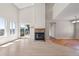 Bright living area with a fireplace, sliding glass doors, and wood-look floors, offering an inviting atmosphere at 8847 Cloverleaf Cir, Parker, CO 80134