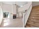 Comfortable living space with a cozy fireplace, light, wood-look floors, and a staircase at 8847 Cloverleaf Cir, Parker, CO 80134