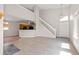 Spacious living area with high ceilings, staircase, and wood-look floors, blending modern design at 8847 Cloverleaf Cir, Parker, CO 80134