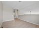 Neutral loft area featuring wood floors, and stairway at 8847 Cloverleaf Cir, Parker, CO 80134
