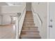 Traditional staircase with natural wood steps and a white railing provides easy access between floors in this lovely home at 8847 Cloverleaf Cir, Parker, CO 80134