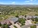 Scenic aerial view of homes nestled in a lush, green landscape with mountain views in the distance at 1975 Wild Star Way, Castle Rock, CO 80104