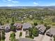 A picturesque aerial view showcasing a beautiful home surrounded by lush greenery and trees in a scenic neighborhood at 1975 Wild Star Way, Castle Rock, CO 80104