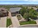 An aerial view showing a home with a well-maintained lawn, landscaping, and a convenient two-car garage at 1975 Wild Star Way, Castle Rock, CO 80104