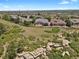 Stunning aerial view of a home with a spacious yard, surrounded by beautiful green landscapes at 1975 Wild Star Way, Castle Rock, CO 80104