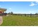 This grassy backyard is perfect for outdoor activities and relaxation, featuring a wood fence and mountain views at 1975 Wild Star Way, Castle Rock, CO 80104