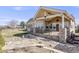 Beautiful backyard featuring a covered patio, rock garden, and black metal fence at 1975 Wild Star Way, Castle Rock, CO 80104