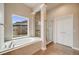A bathroom featuring a large window, tub, and walk-in shower at 1975 Wild Star Way, Castle Rock, CO 80104