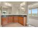 Bathroom with double vanities, granite countertops, and ample storage at 1975 Wild Star Way, Castle Rock, CO 80104