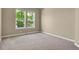 Neutral bedroom featuring carpeted floors and multiple windows for natural light at 1975 Wild Star Way, Castle Rock, CO 80104