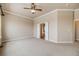 Large bedroom with bright natural lighting features white trim, ceiling fan, and ensuite bathroom at 1975 Wild Star Way, Castle Rock, CO 80104