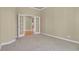 Bedroom featuring neutral carpet and paint with double doors leading to another room at 1975 Wild Star Way, Castle Rock, CO 80104