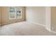 Carpeted bedroom with base trim, double-hung windows offering neighborhood views and lots of natural light at 1975 Wild Star Way, Castle Rock, CO 80104