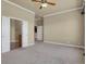 Spacious bedroom with neutral carpet, trim details, and an ensuite bathroom at 1975 Wild Star Way, Castle Rock, CO 80104