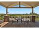 Covered deck area with seating offering views of the surrounding landscaped yard at 1975 Wild Star Way, Castle Rock, CO 80104