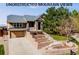 Charming two-story home with a stone facade, attached two-car garage, and well-maintained landscaping at 1975 Wild Star Way, Castle Rock, CO 80104