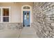 Charming front entrance with blue front door and stone accents at 1975 Wild Star Way, Castle Rock, CO 80104