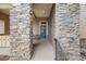 Stone accented front entrance with blue front door and address number 1975 at 1975 Wild Star Way, Castle Rock, CO 80104