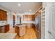Bright eat-in kitchen features hardwood floors, stainless steel appliances, and a gas cooktop island at 1975 Wild Star Way, Castle Rock, CO 80104