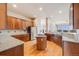 Modern kitchen with granite countertops, wood cabinets, and stainless steel appliances at 1975 Wild Star Way, Castle Rock, CO 80104