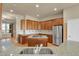 Kitchen features wood cabinets, a center island cooktop, and stainless steel appliances at 1975 Wild Star Way, Castle Rock, CO 80104